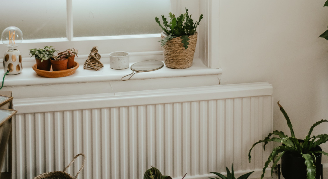 a radiator under a bathroom window